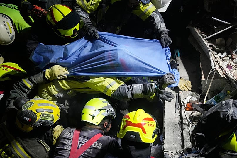Rescue workers pull a survivor Daniela Largo from the rubble the day after an earthquake struck Pereira, Colombia, Tuesday, 11 August 2026. 