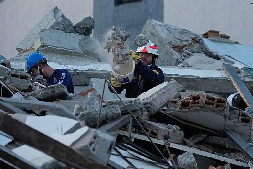 Rescue workers clear debris the day after an earthquake struck Pereira, Colombia, Tuesday, 11 August 2026.