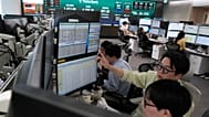 FILE - Currency traders work at the foreign exchange dealing room of the Hana Bank headquarters in Seoul, South Korea, Wednesday, Aug. 12, 2026. (AP Photo/Ahn Young-joon)