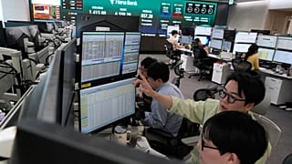 FILE - Currency traders work at the foreign exchange dealing room of the Hana Bank headquarters in Seoul, South Korea, Wednesday, Aug. 12, 2026. (AP Photo/Ahn Young-joon)