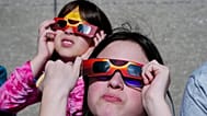 FILE- Evelyn Sander, right, and Sopfia Munoz, of Indianapolis, look at the eclipse during total eclipse viewing event in Indianapolis,Monday April 8, 2024. 