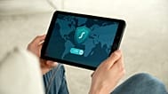 A person holding tablet with VPN connection screen for secure internet browsing.