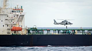 French soldier rappels down from a helicopter to the Deyna tanker, suspected of being part of Russia's shadow fleet