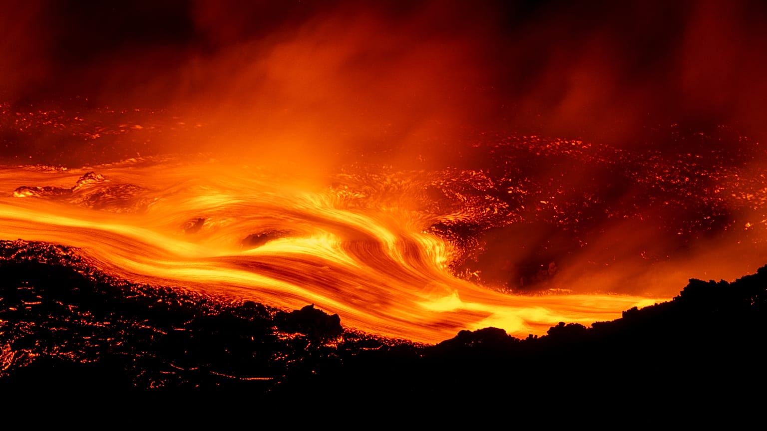 Mount Etna's eruption continues, with lava flows along its slopes seen from Serracozzo on 11 August 2026. (AP Photo/Simone Genovese)