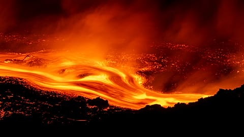 Mount Etna's eruption continues, with lava flows along its slopes seen from Serracozzo on 11 August 2026. (AP Photo/Simone Genovese)