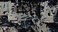 Volunteers and rescue workers use buckets to remove debris of a collapsed building a day after an earthquake struck Cali, 11 August, 2026