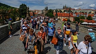 Un groupe de touristes marche lors d'une visite guidée à Prague, en République tchèque, le mercredi 5 juillet 2023.