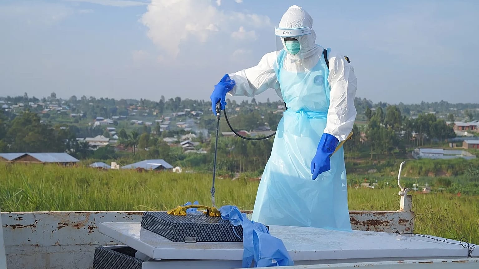 A health worker sprays the coffin containing the remains of Jacques Lobo Dhena, who died of Ebola, during a burial service in Bunia, Ituri province, eastern Congo, Wednesday, 