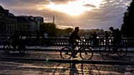 Cyclists ride across a bridge over the Seine at sunset on Thursday 28 August 2025 in Paris.