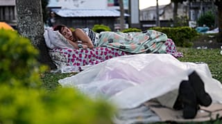 People sleep in a park after their homes were damaged by an earthquake that struck Pereira