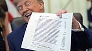 El presidente Donald Trump muestra una imagen de Truth Social durante una reunión para firmar una orden sobre vacunas en el Despacho Oval, el diez de agosto de 2026