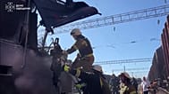 Emergency workers clearing debris of train cabin after it was struck by a Russian drone. Odesa region, Ukraine, 13 August 2026.