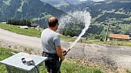 Juerg Klopfenstein, responsable de la neige artificielle à Adelboden-Lenk, arrose une route près des pistes dans la vallée de Lenk, en Suisse, le 3 août 2026.