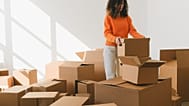 A woman packing boxes to move houses