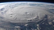A stunning aerial view of Earth with a massive swirling hurricane, highlighting meteorological beauty