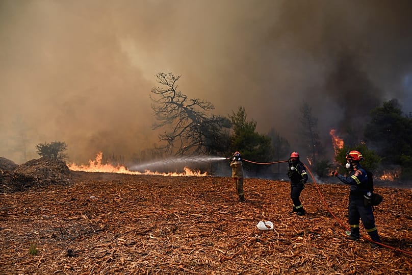Firefighters operate during a wildfire near Porto Germeno, 2 August, 2026