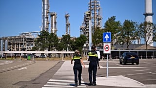 Police officers walk to a refinery and fuel terminal run by Gunvor Energy in Rotterdam, 13 August, 2026