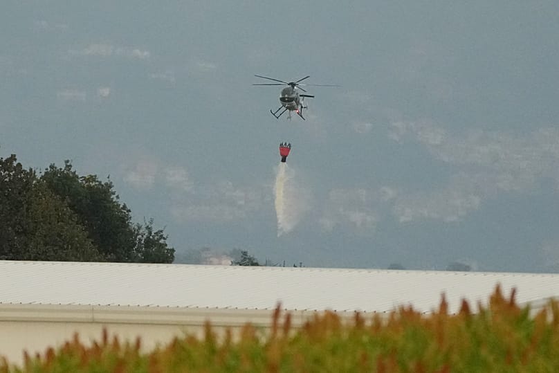A helicopter drops water over the scene of an explosion at an ammunition plant in Colleferro, 13 August, 2026