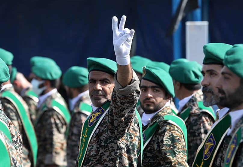 FILE: A member of Iran's Basij militia flashes a victory sign during a military parade commemorating the 1980-88 Iraq-Iran war, near Tehran, 22 September 2022