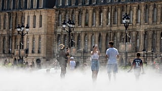 People walk through mist at the Miroir d'Eau reflecting pool outside the Place de la Bourse in Bordeaux, 13 August, 2026