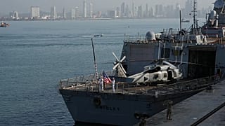 Sailors raise the flag aboard a U.S. Navy ship taking part in a multinational military exercise in Panama City, Thursday, Aug. 13, 2026. (AP Photo/Matias Delacroix)