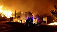  Firefighters battle blaze fanned by wind