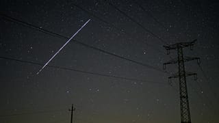 FILE - A string of SpaceX StarLink satellites passes over Salgotarjan, Hungary, early May 12, 2021. 