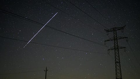 FILE - A string of SpaceX StarLink satellites passes over Salgotarjan, Hungary, early May 12, 2021. 