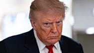 US President Donald Trump speaks with reporters while on Air Force One en route to Oakland County International Airport, Michigan, 27 July 2026