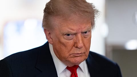 US President Donald Trump speaks with reporters while on Air Force One en route to Oakland County International Airport, Michigan, 27 July 2026