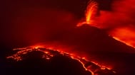 Eruptive activity continues on Mount Etna, where two lava flows continue to descend on the slopes of the volcano, as seen from Nicolosi near Catania, Italy, Tuesday Aug. 26, 2