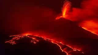 Eruptive activity continues on Mount Etna, where two lava flows continue to descend on the slopes of the volcano, as seen from Nicolosi near Catania, Italy, Tuesday Aug. 26, 2