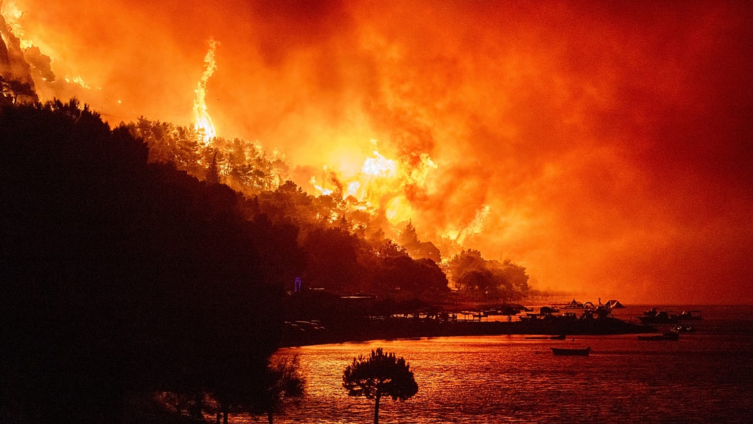A wildfire approaches a beach on the Adriatic coast near Omis, southern Croatia, early Friday, Aug. 14, 2026. 