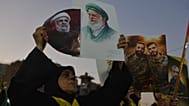 سيدة تحمل صور نعيم قاسم والمرشد الإيراني الراحل علي خامنئي خلال تجمع في الضاحية الجنوبية لبيروت، بالتزامن مع جنازته الأربعاء 8 يوليو 2026