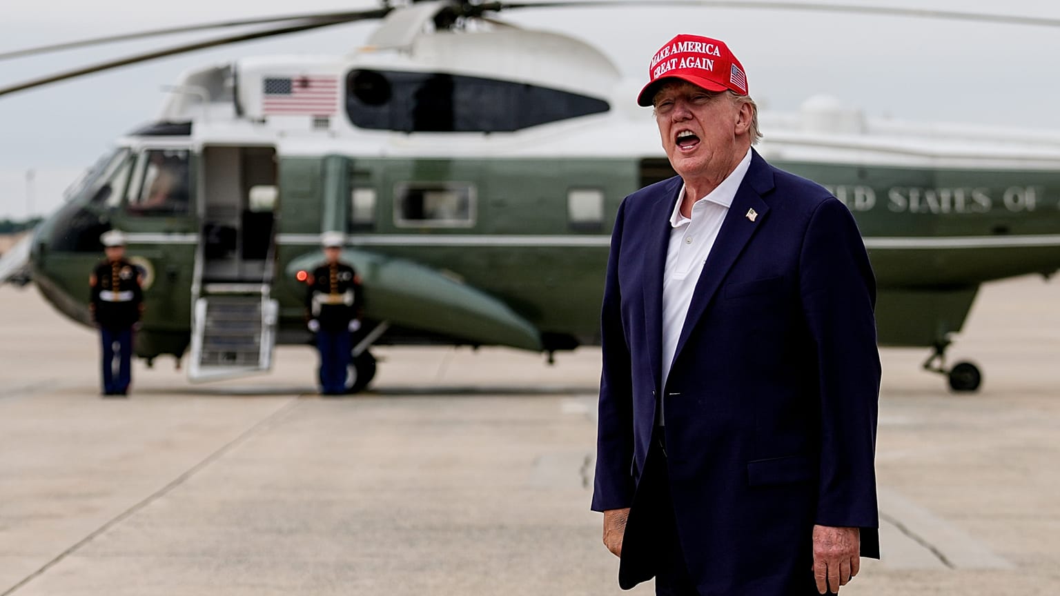 President Donald Trump yells to reporters after disembarking Air Force One, Sunday, Aug. 16, 2026