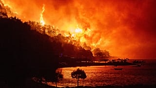 A wildfire approaches a beach on the Adriatic coast near Omiš, 14 August, 2026