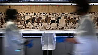 Workers and volunteers prepare to pack the Bayeux tapestry to transfer to the British Museum