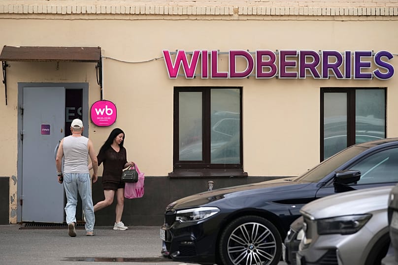 A woman carrying a package leaves an outlet of Russia's major online retailer Wildberries in Moscow, 22 July, 2026