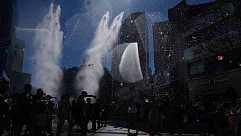 Participants spray water from their water guns and throw water balloons during a water gun festival in Seoul, South Korea, Saturday, Aug. 8, 2026.