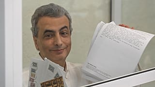 Senior member of the Yabloko party Lev Shlosberg stands in the defendant's box prior to a verdict in the case against him being delivered, in a court in Pskov, 17 August 2026