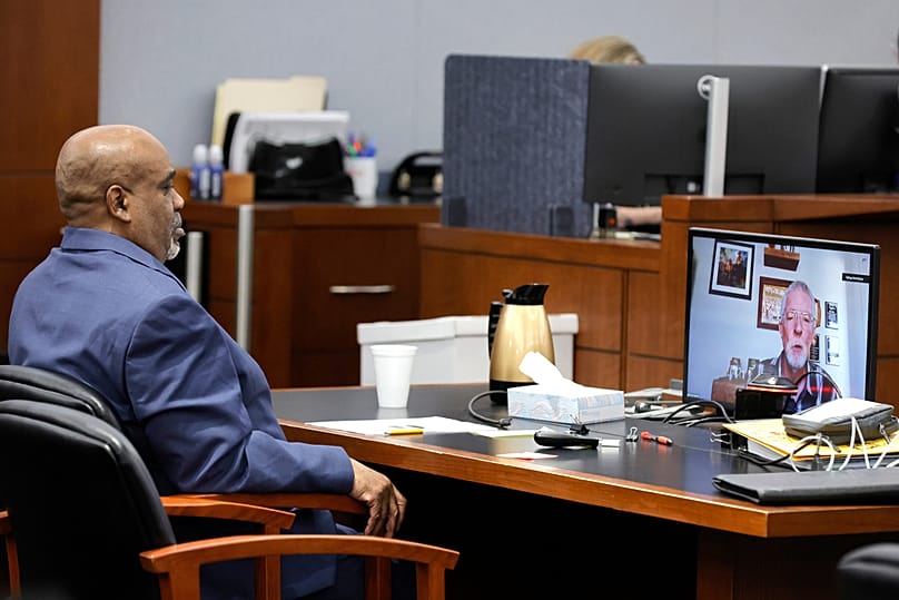 Duane Davis listens as Brent Becker, a retired Las Vegas PD Police homicide detective, testifies by video feed during his murder trial, in Las Vegas, Monday, 17 Aug, 2026