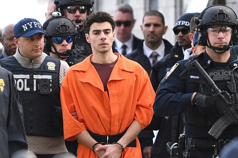 FILE - Luigi Mangione, a suspect in the fatal shooting of UnitedHealthcare CEO Brian Thompson, is escorted by police, Thursday, Dec. 19, 2024, in New York