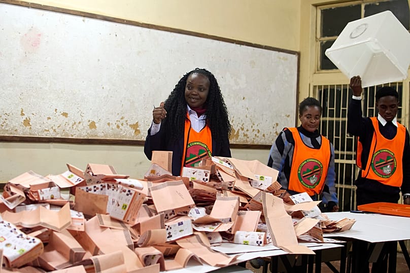 Election workers count ballots at a polling station in Lusaka, 13 August, 2026