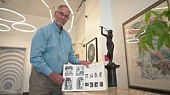 Art dealer Bill DeLind shows a picture of a Pablo Picasso sketch (upper left) stolen from his shop DeLind Fine Art Appraisals in 2018 in Milwaukee on Aug. 14, 2026. 