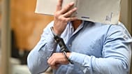 One of the defendants in a trial against three Ukrainians accused of acting as agents on behalf of Russia enters the court in Stuttgart, 18 August, 2026