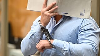 One of the defendants in a trial against three Ukrainians accused of acting as agents on behalf of Russia enters the court in Stuttgart, 18 August, 2026