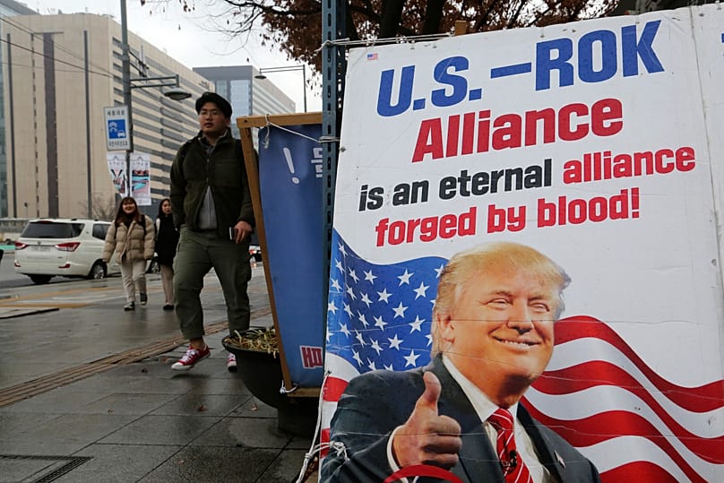 A poster showing US President Donald Trump displayed to demand the strength of the South Korea-US alliance near the Foreign Ministry in Seoul, 30 December, 2019