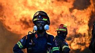 File - A firefighter stands as flames rising during a wildfire near Porto Germeno, northwest of Athens, Greece, Sunday, 2Aug. 2026.