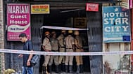 Firefighters stand outside a building after a fire in Kolkata, India, on Wednesday, 19 Aug. (AP Photo/Bikas Das)