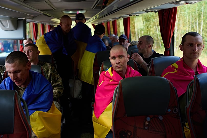 Ukrainian soldiers sit in a bus after returning from captivity after a Prisoners of War exchange between Russia and Ukraine, in Chernyhiv region, Ukraine. Aug. 19, 2026.